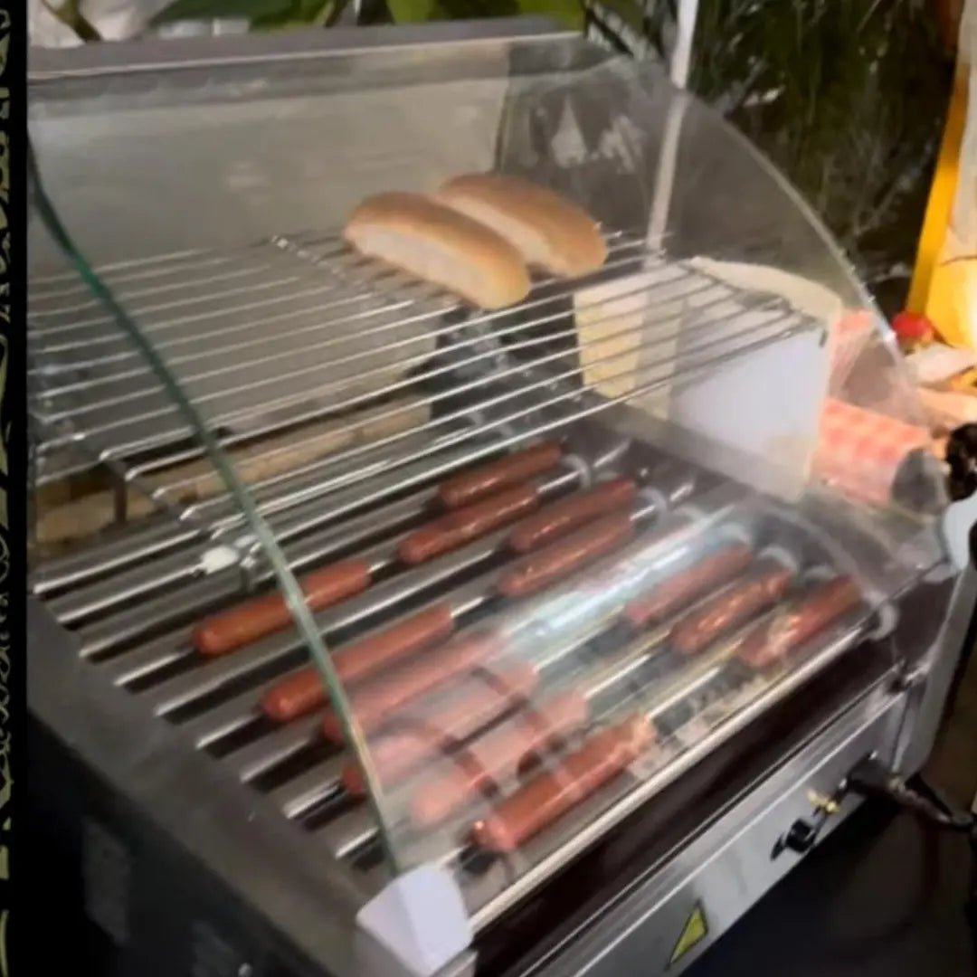 Hot dog station rental in Miami: a Fantasy Entertainments roller grill cooking hot dogs with warm buns ready to serve.