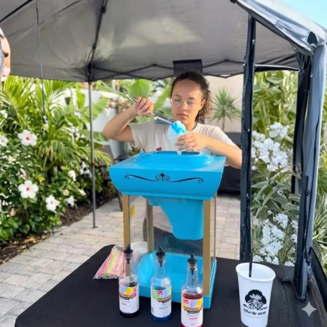 Snow cone machine rental in Miami: a Fantasy Entertainments attendant serving fresh snow cones under a canopy at an outdoor event.